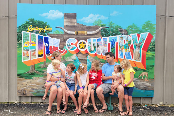 Family picture in front of the Hill Country mural.