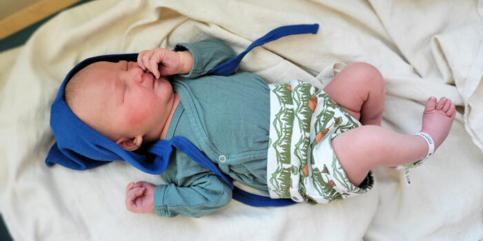 Blue baby bonnet on a newborn.