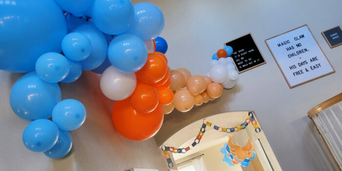 Making a balloon garland makes a big impact at a Bluey birthday party.